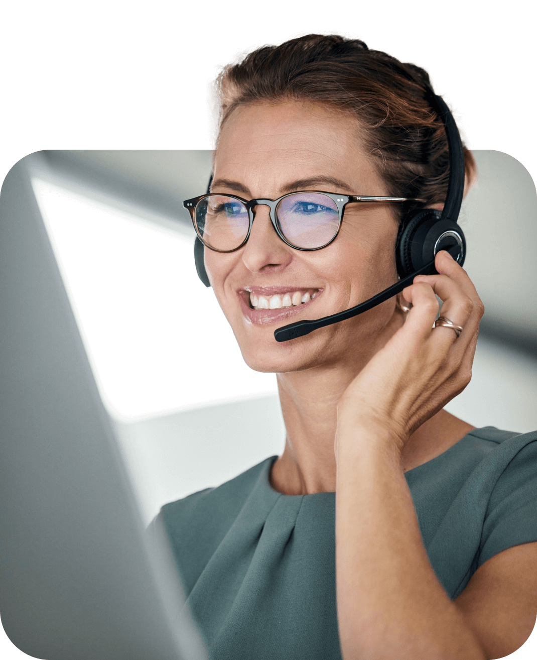 Female contact center employee smiling with her headset on