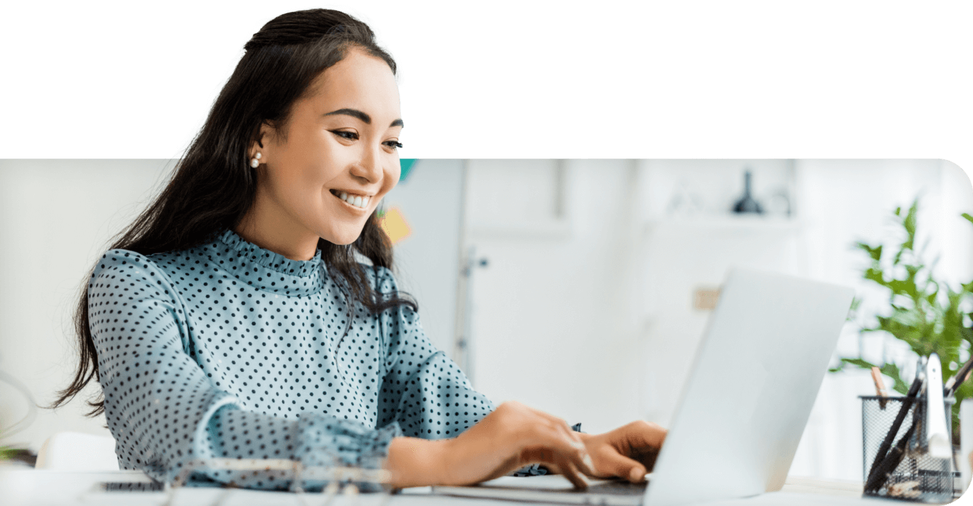 Woman smiling at laptop working on back office automation