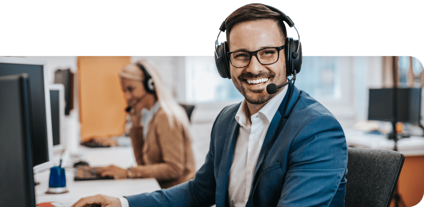 Customer support man in suit smiling while wearing headset