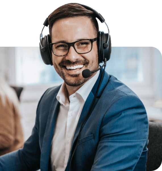Customer support man in suit smiling while wearing headset