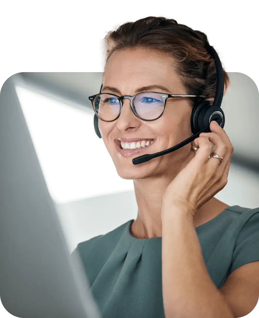 Female contact center employee smiling with her headset on