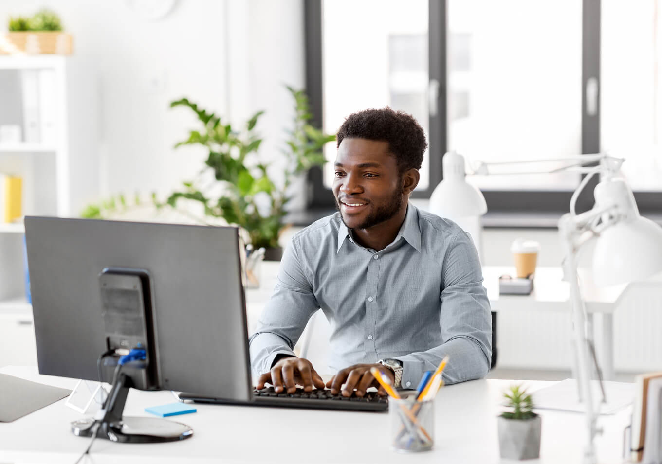 Man typing on computer with real-time automation